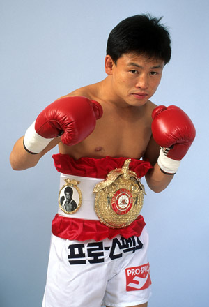 ATLANTIC CITY - FEBRUARY 2,1991: Myung Woo Yuh poses with his belt for a portrait in Atlantic City, New Jersey. (Photo by: The Ring Magazine/Getty Images)